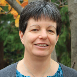 Woman with short dark hair, smiling.