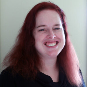 Woman with long red hair, smiling