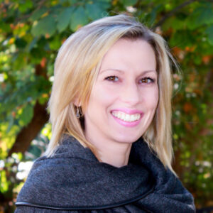 Blonde woman smiling with dark jacket